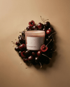 Red Wine and Black Cherry candle surrounded by fresh cherries