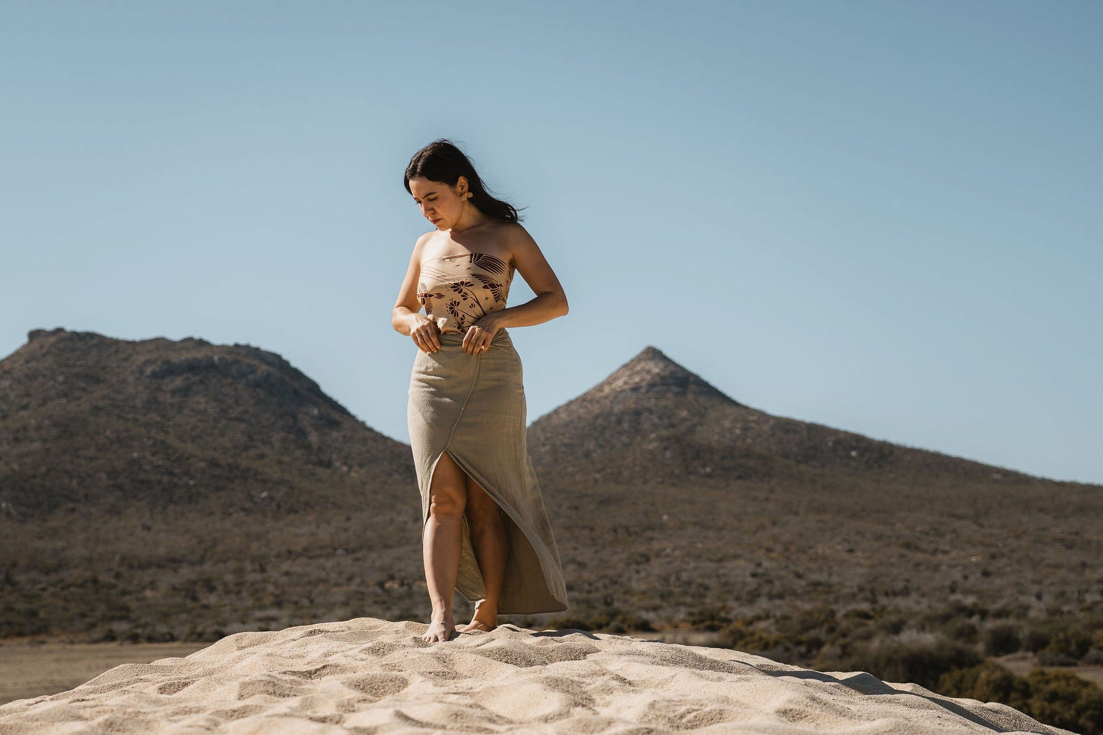 woman standing with silk scarf from anne sidora collection used as a top