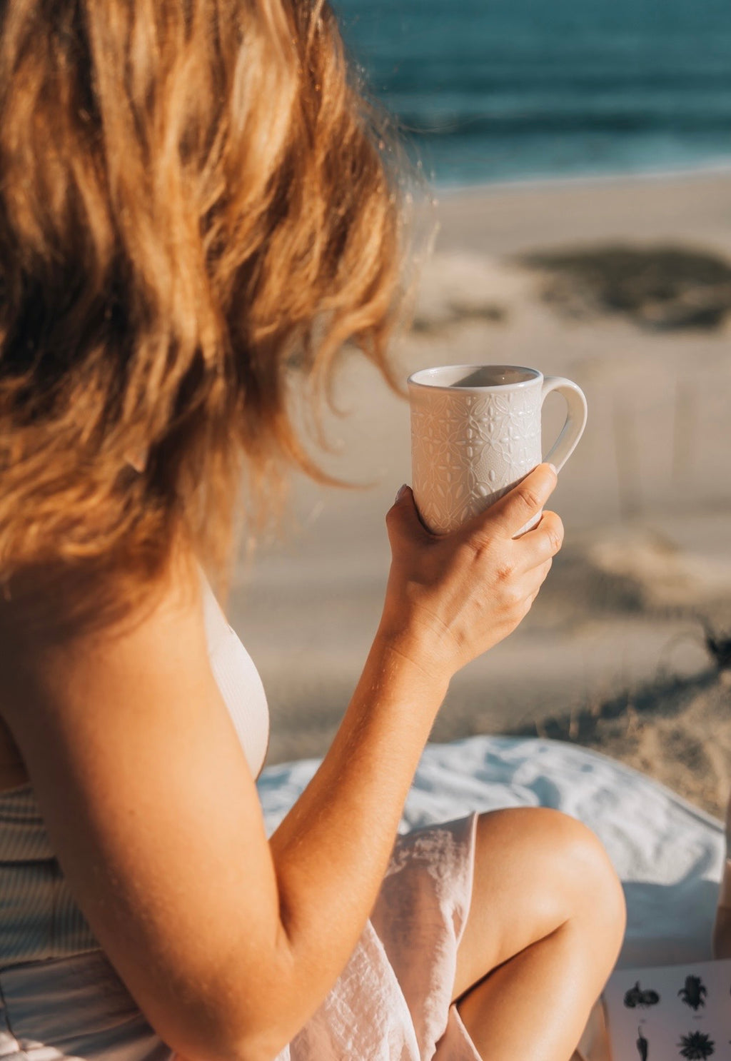 delicate luxury white ceramic mug made in mexico. picture by the beach
