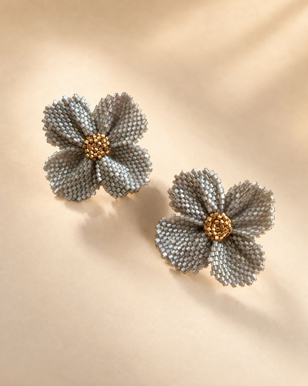 Damiana Gris Earrings, handwoven silver grey Miyuki bead flower studs with gold center by Anne Sidora Poetry Atelier, Los Cabos