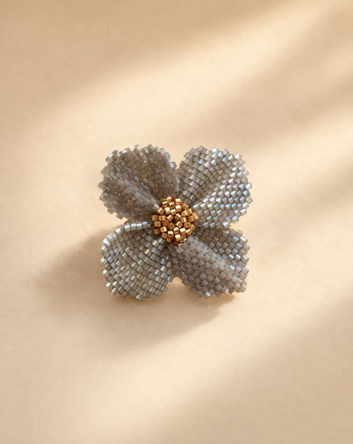Damiana Gris Ring, handwoven silver grey Miyuki bead flower ring with gold center by Anne Sidora Poetry Atelier, Los Cabos