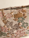 Flor de Sol Pouch detail, golden plate Poetry in the Ordinary and monogram charm