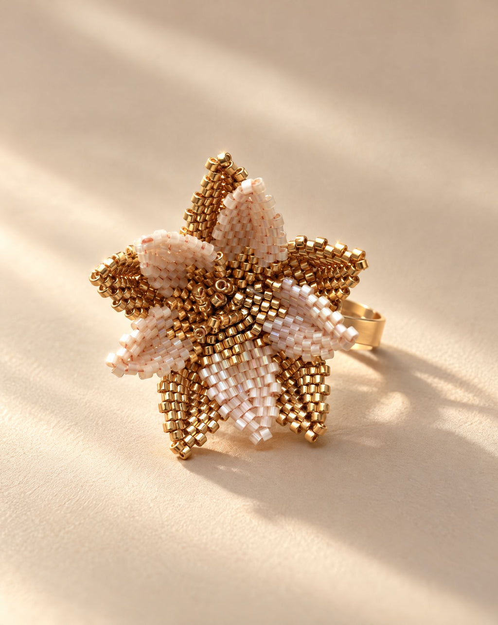 Flor del Alba Beige Ring side view, layered beaded petals on adjustable gold plated band, handmade by Anne Sidora