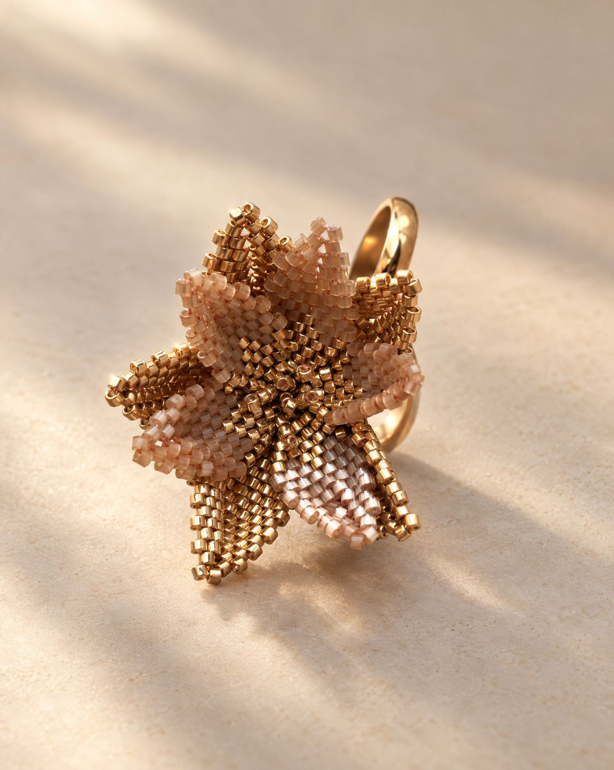 Flor del Alba Champagne Ring side view, layered beaded petals on adjustable gold plated band, handmade by Anne Sidora