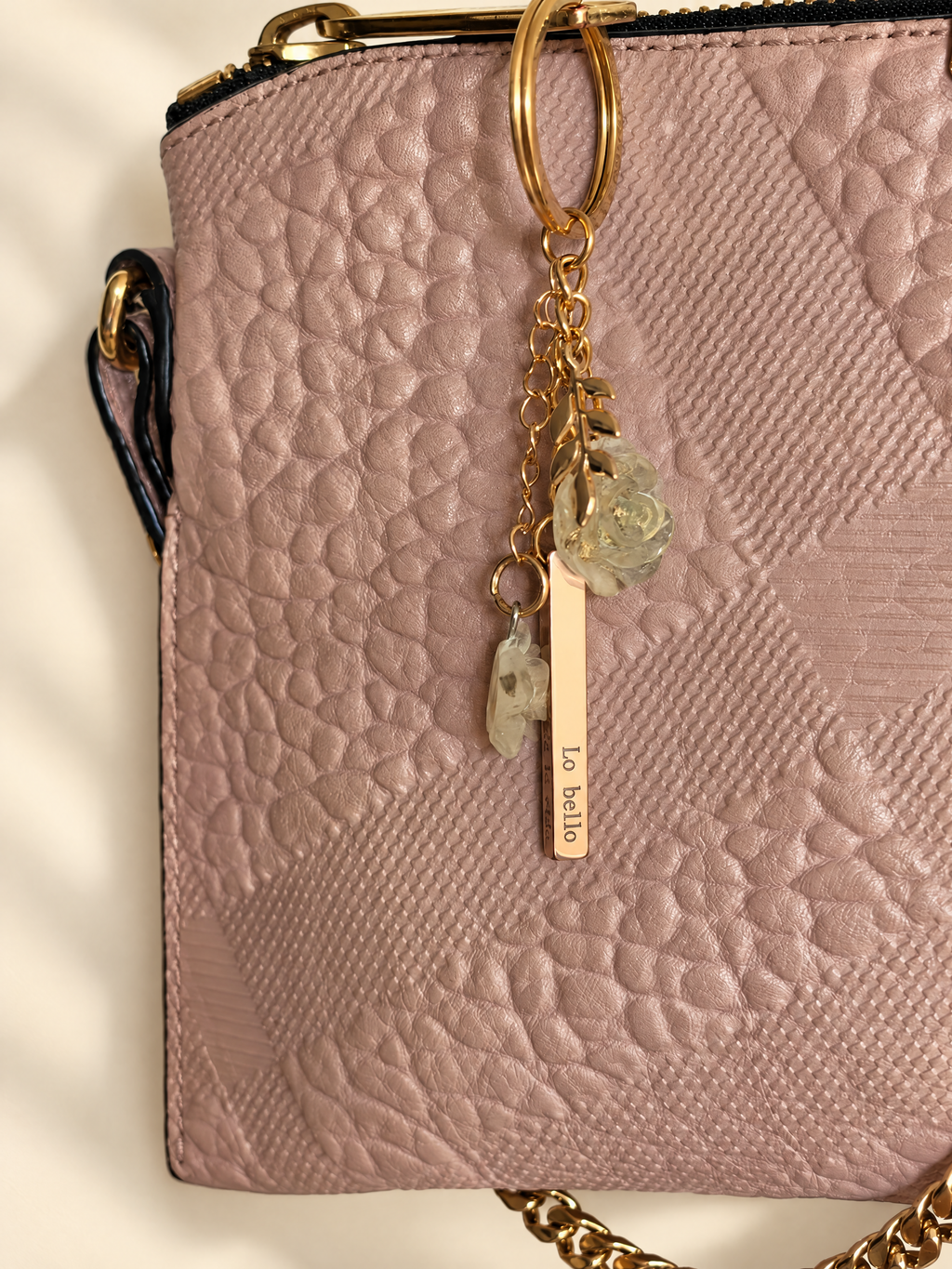 Poesía Keyring worn on a pink leather bag