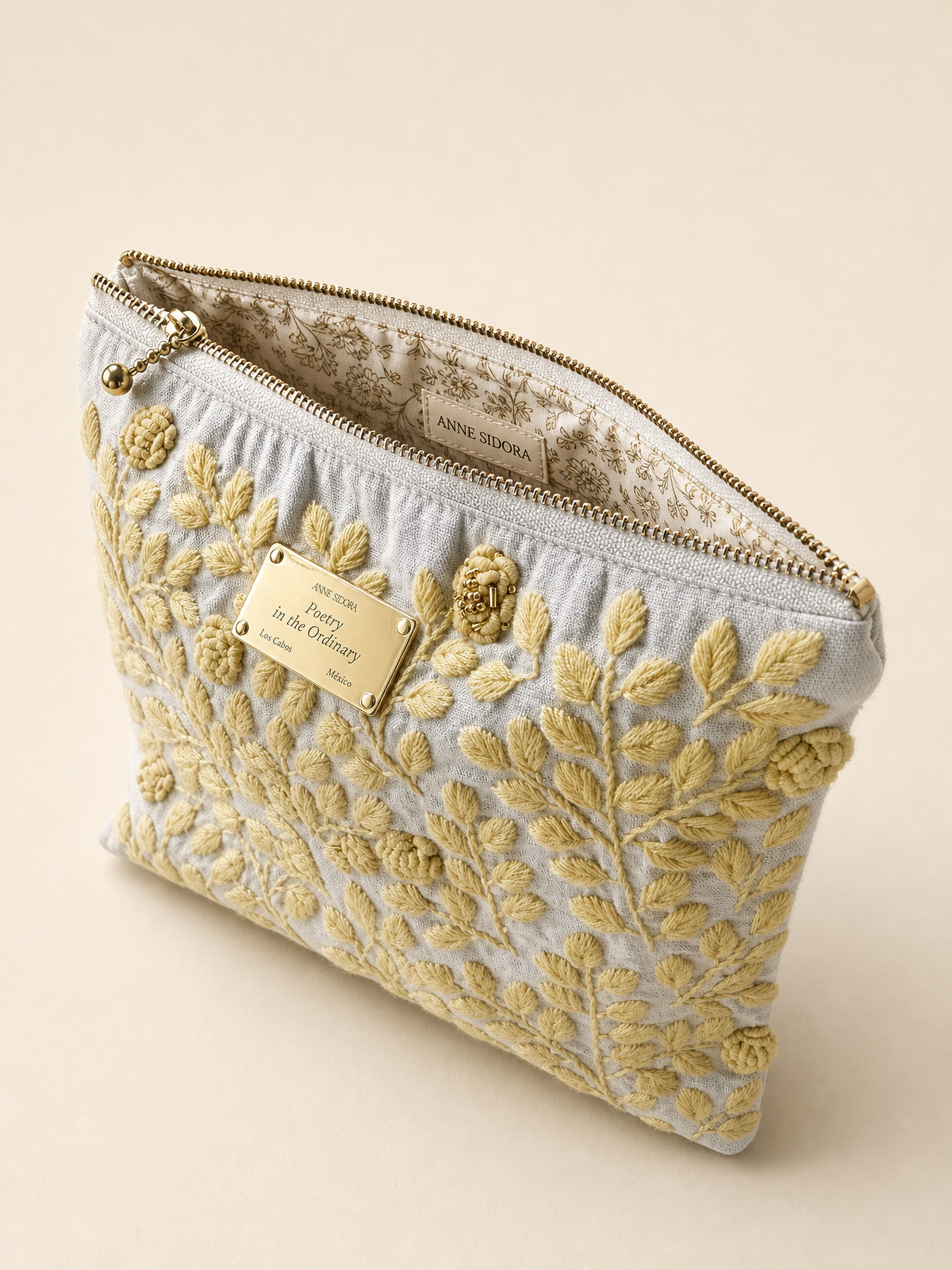 Rosa de Día embroidered pouch open showing printed cotton lining